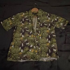 Small Ripndip jungle shirt with white cats printed on it.